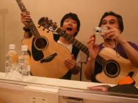 Me and Akihiro Tanaka in the dressing room of “Mojo West” in Kyoto on 8/8/09. Aki is a young guitarist full of promise.